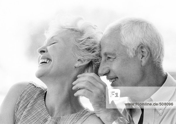 Mature man and woman smiling  close-up  B&W