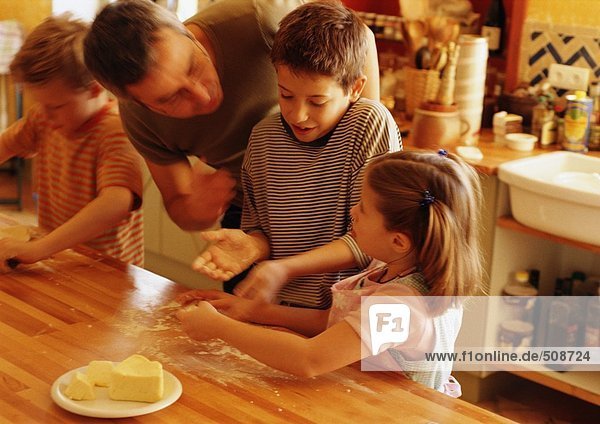 Man helping children in kitchen  blurred motion