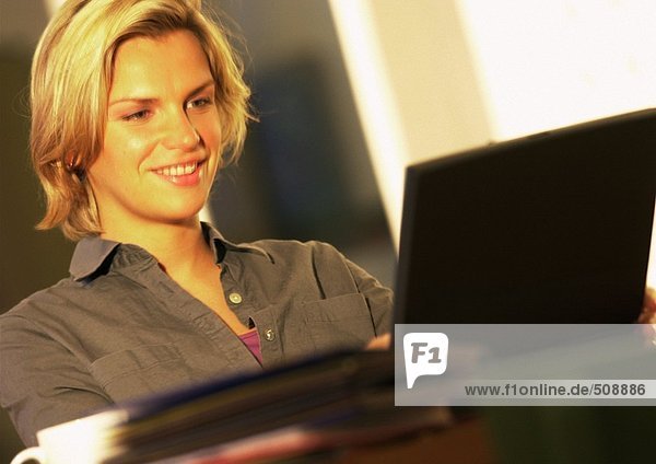 Woman using laptop computer  smiling