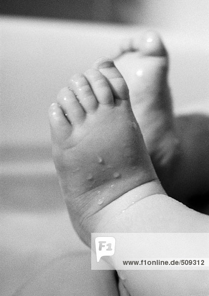 Baby's wet feet  close-up  b&w