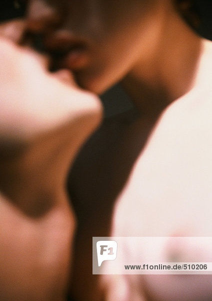 Nude couple kissing  close-up  blurred