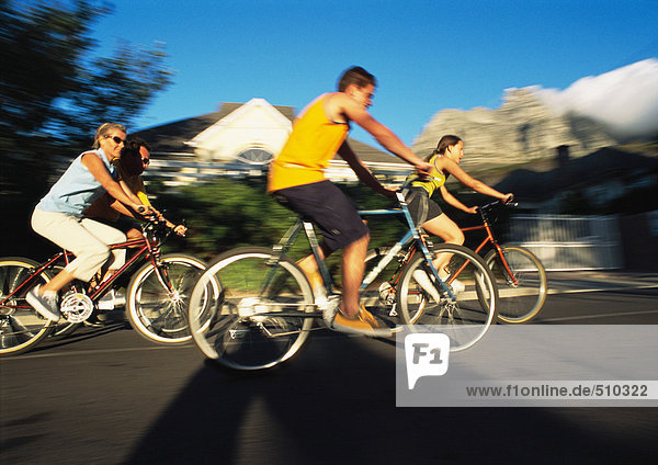 Family riding bikes  side view  blurred motion