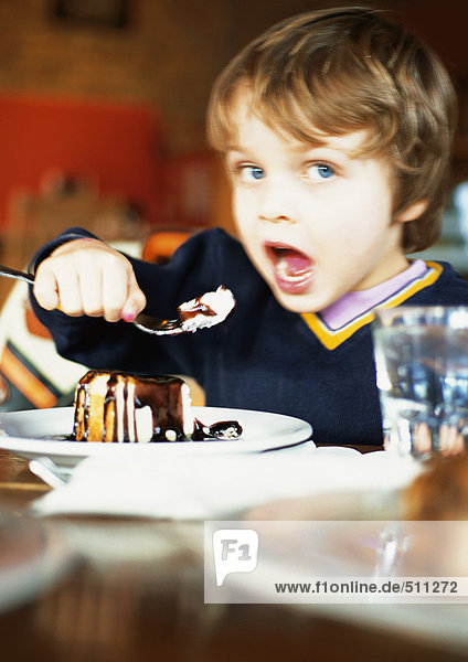 Little boy eating dessert  portrait.