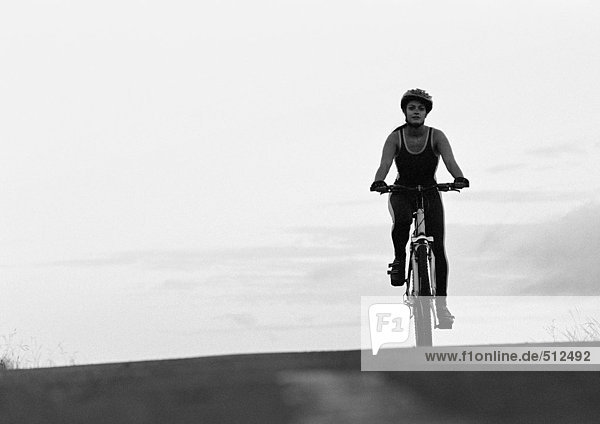 Woman cycling  b&w.