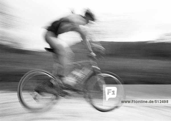 Man cycling  side view  blurred  b&w.