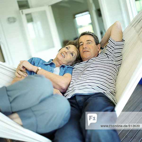 Mature couple lying in a hammock