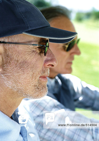 Two mature men wearing sunglasses  close-up  side view