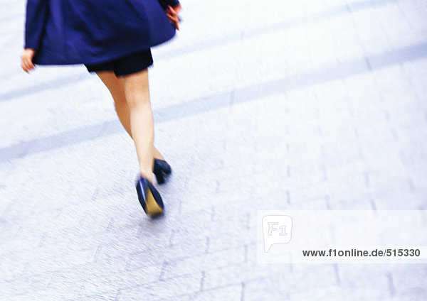 Businesswoman walking  low section  tilt  blurred motion