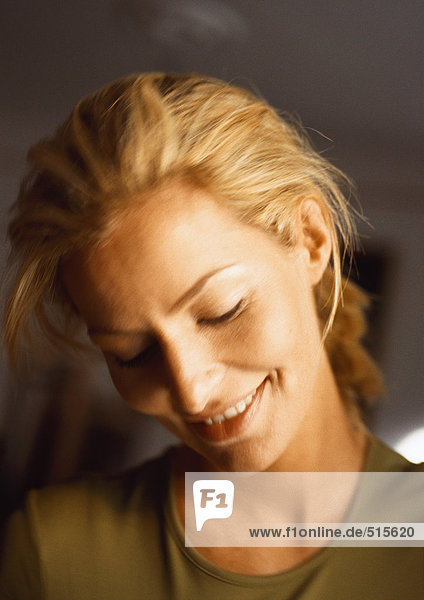 Woman  head down  smiling  close-up  portrait.