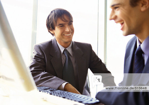 Businessmen laughing together  head and shoulders