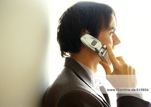 Businessman on cell phone  side view  head and shoulders