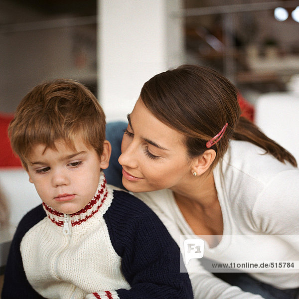 Woman leaning over son's shoulder