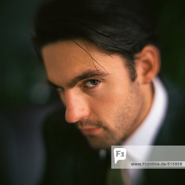 Businessman looking at camera  side view  portrait