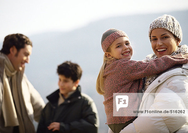 Family in warm clothes  outside