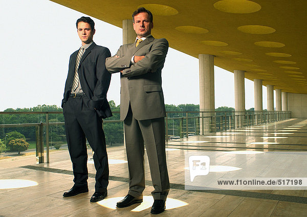Two businessmen looking into camera