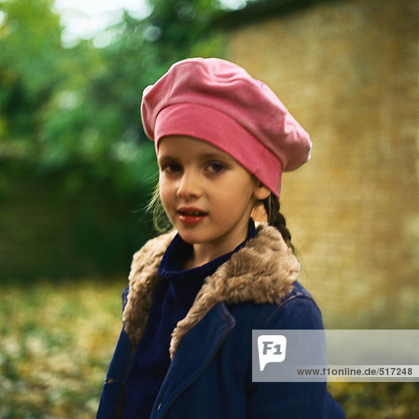 Girl outside wearing pink beret  winter coat  looking at camera