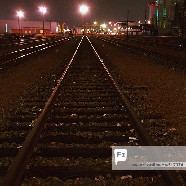 Train tracks in railyard at night