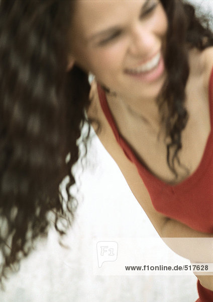 Teenage girl smiling looking away  blurred portrait