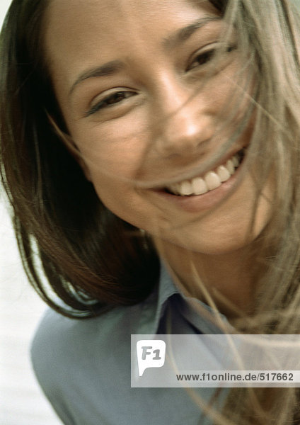 Woman smiling  hair in face  close up portrait