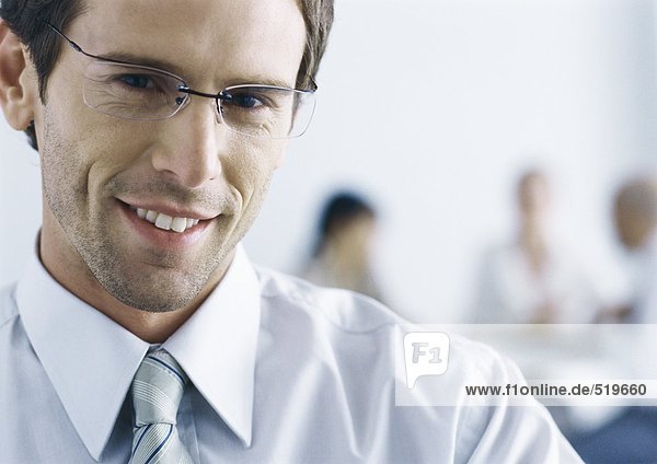 Businessman with glasses  smiling at camera