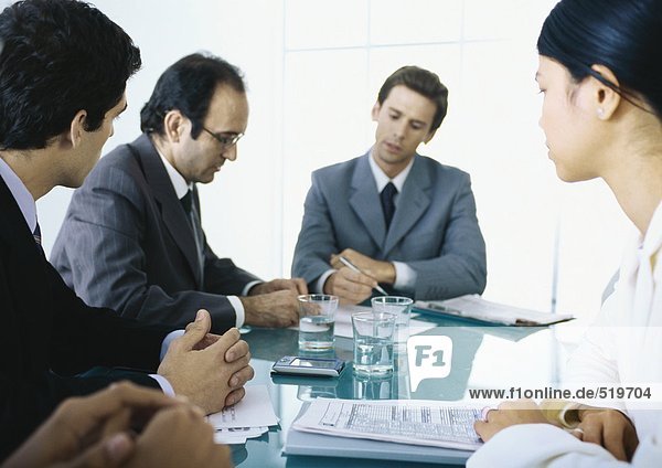 Businesspeople sitting at table having meeting