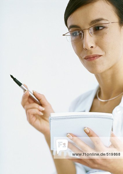 Woman holding notepad and pen