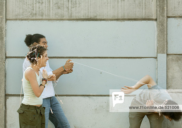 Young people playing with party string