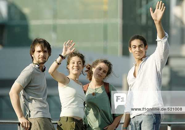 Group of young people waving