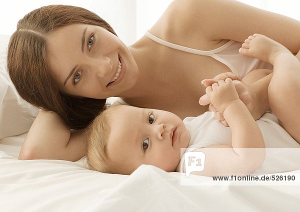 Baby and mother on bed  portrait