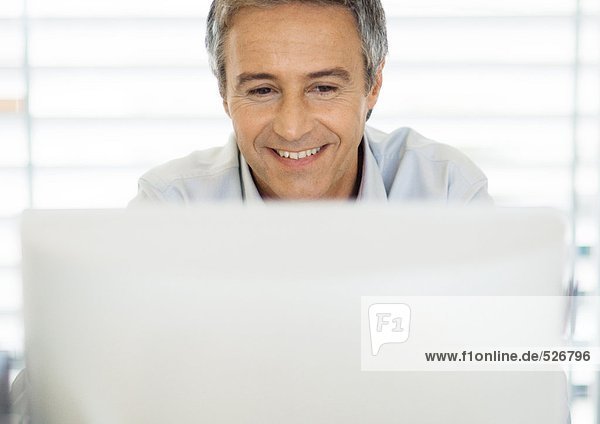 Middle-aged man using laptop