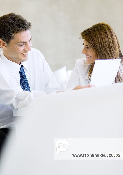 Two business colleagues working together and laughing