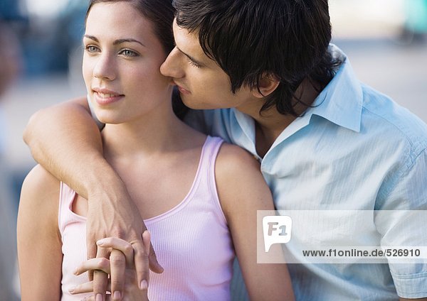 Young couple  man leaning over woman's shoulder
