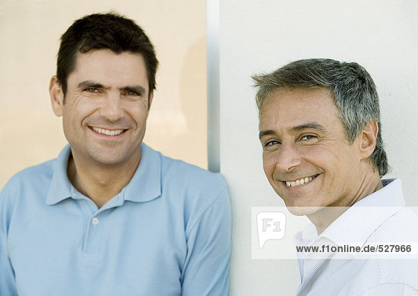 Two men  smiling and looking at camera  portrait