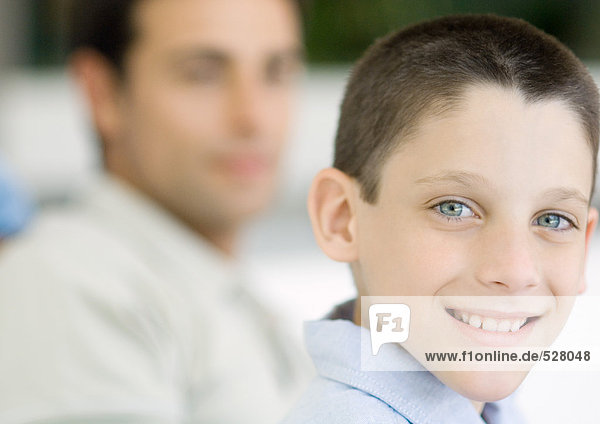 Boy  portrait with father in background