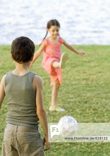 Boy and girl playing soccer