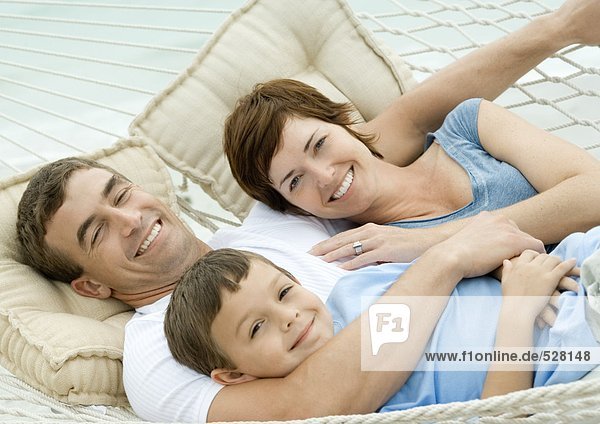 Family lying in hammock  smiling