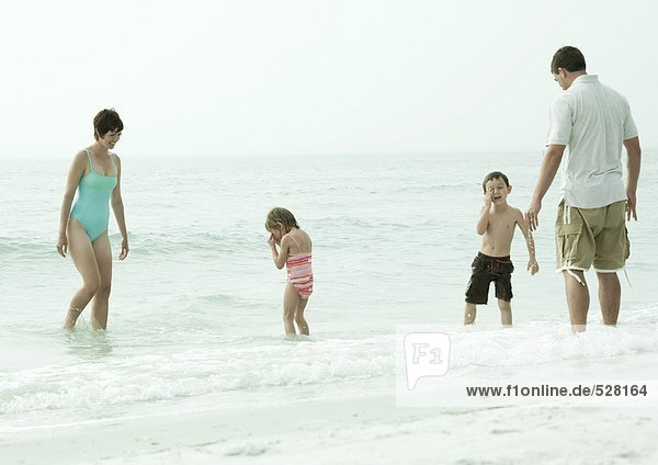 Family playing in surf