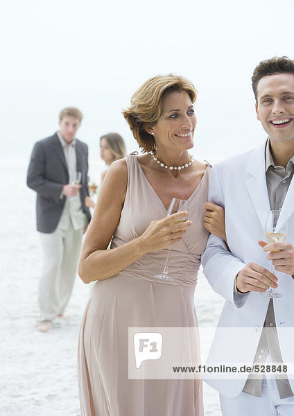 People dressed in formal clothing on beach