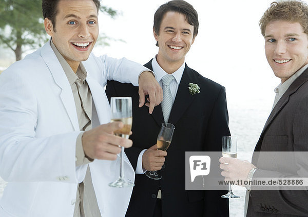 Bräutigam stehend mit zwei männlichen Freunden