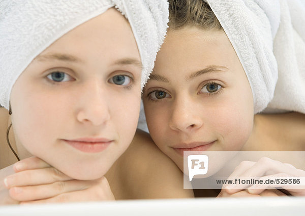 Zwei Mädchen mit Haaren in Handtücher gewickelt.