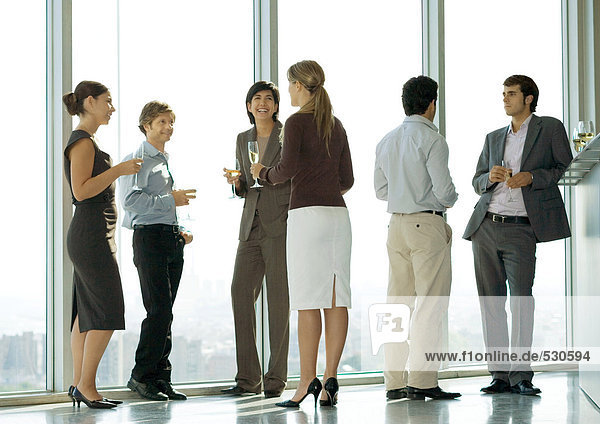 People standing with glasses during office party