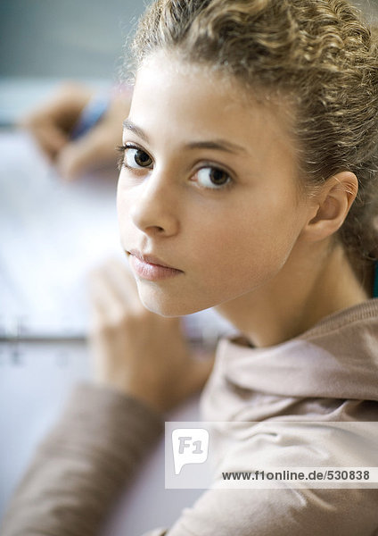Preteen girl doing homework  portrait