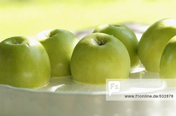 Grüne Äpfel in Flüssigkeit  Nahaufnahme
