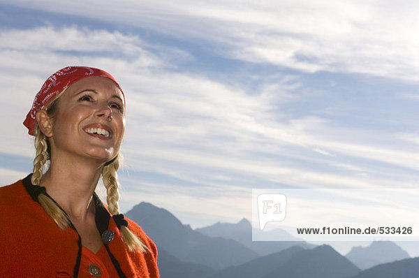 Young woman in mountain  looking up