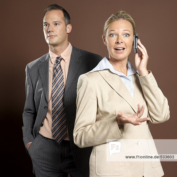 Businessman and businesswoman  woman holding mobile phone