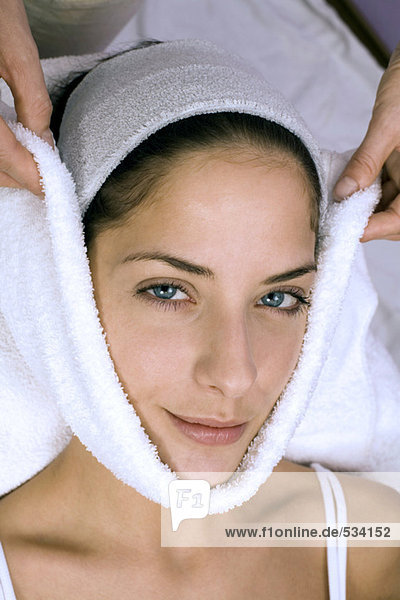 Woman receiving face treatment  portrait  smiling  elevated view