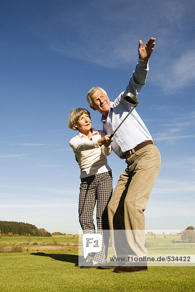 Germany  Bavaria  senior couple playing golf