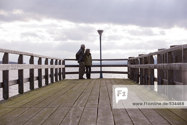 Senior couple standing on jetty