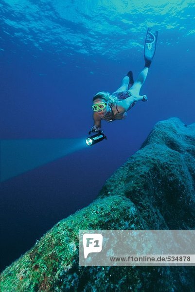 Female scuba diver swimming underwater  Corfu  Greece