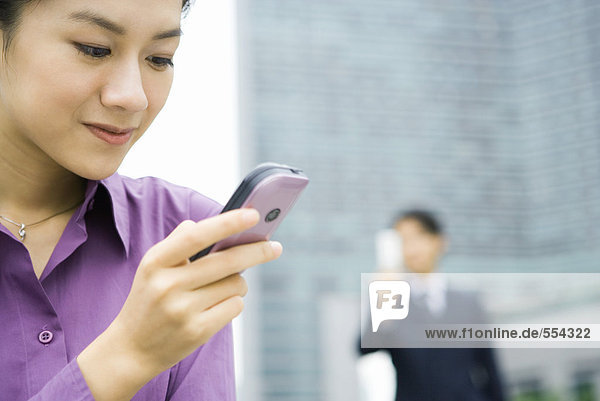 Businesswoman using messaging phone  close-up